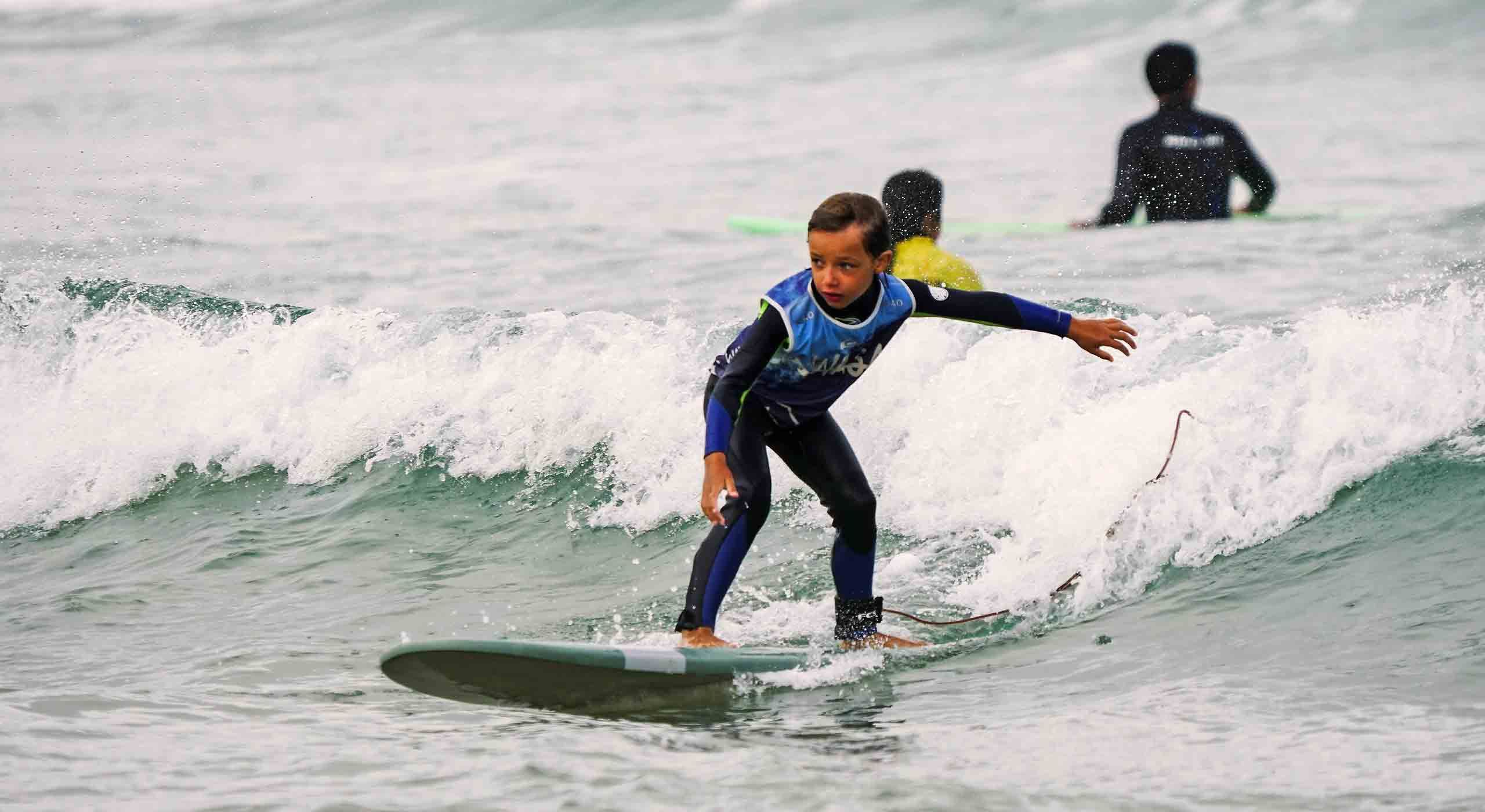 jeune garçon sur une petite vague pendant un stage de surf enfant à capbreton
